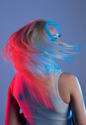a woman with her hair blowing in the wind